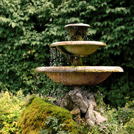 the sound of running water of green garden water fountains
